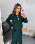 Stylish midi dress with a slit made from polyester and viscose, suitable for elegant occasions, shown in the image.