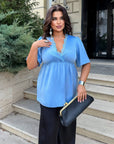 Satin blouse with lace made from polyester, viscose and elastane, smooth and elegant, shown on a model.