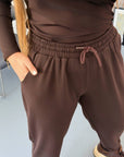Knit joggers with New Year design, white and black from brand NewYear25, 60% cotton, 35% polyester, 5% elastane