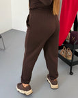 Knitted joggers with New Year design, made from cotton, polyester and elastane, suitable for comfort and style.