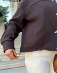 Cropped denim jacket made from cotton and polyester with elastane, shown in the photo, stylish and comfortable model from a fashion brand.