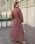 Long dress with a removable peplum belt made from polyester and elastane, model with elegant design and long sleeves.