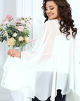 Elegant chiffon dress with a cape, white, with satin details and delicate design, suitable for special occasions.