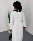 Woman wears fitted dress with a statement collar, polyester, viscose and spandex, elegant everyday style.