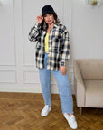 Oversized checked shirt made from cotton and polyester, model with loose fit and classic pattern, suitable for everyday outfits.