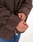 Lightweight hooded jacket made from polyester, image of blue garment with hood and zip at the front.