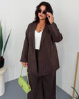 Striped business-style set with polyester, viscose and spandex, shown on a model.