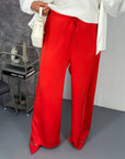 Wide satin trousers with smooth texture and stretchy waistband, made from polyester and elastane, in an elegant style.