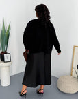 Satin dress and soft jumper set, polyester, viscose and elastane, in an elegant style, image of a model against a white background.