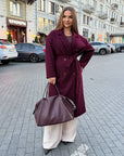 Long faux cashmere coat in a blend of polyester, viscose and wool, shown on a model in the image.