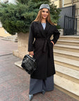 Long faux-cashmere coat with polyester, viscose and wool, shown on a model, suitable for winter wardrobe.