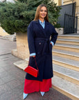 Long faux cashmere coat with polyester, viscose and wool, shown on a model, with classic design and soft texture.