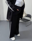Blazer and wide-leg trouser set for IT sector, polyester, viscose and spandex, model in a neutral colour.