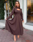 Elegant midi dress in viscose and polyester, shown on a model, with a clean design and elegant silhouette.