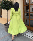 Elegant midi dress in viscose and polyester with a clean design and smooth texture, suitable for formal events.