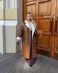 Long faux leather coat, 100% polyamide, with a stylish design and collar, as shown in the photo.
