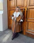 Long faux leather coat, 100% polyamide, with a classic cut and modern style.