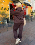 Velour hooded set in polyester and spandex, a stylish and comfortable outfit for everyday wear.
