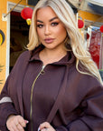 Velour hooded set in polyester and spandex, with a soft texture and fashionable design.