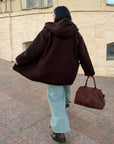 Short faux fur coat in polyester and acrylic, black, with a fluffy texture and stylish design.