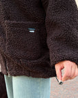 Short faux fur coat in polyester and acrylic, shown on a model wearing a modern winter piece in white.