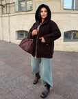 Short faux fur coat in polyester and acrylic, in white, shown on a model, with a stylish and warm design.