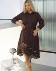 Flared dress with cut-outs and stones, polyester, viscose and spandex, with a fashionable design and details.