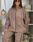 Fleece set with stripes, polyester and elastane, shown on a model, with long sleeves and a comfortable design.