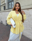 Cropped cardigan with a belt made from cotton and polyester, stylish design, shown on a model against a white background.