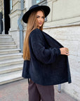 Cropped cardigan with a belt made from polyester and viscose, image of a model, worn stylish and modern cardigan.