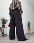 Women's wide-leg trousers made from polyester, viscose and spandex, shown on a model in the image.