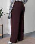 Women's wide-leg trousers made from polyester, viscose and spandex, in black, folded and shown at the sides