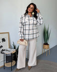 Checked shirt with a belt made from cotton and polyester, model with long sleeves and classic design, in white and black.