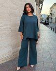 Loose-fitting set with rhinestones, made from polyester, viscose and lycra, shown on a model.