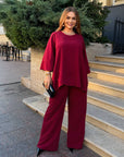 Loose-fitting set with rhinestones, made from polyester, viscose and lycra, shown on a model, details of the elegant design.