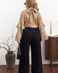 Stylish women’s blouse with ruffles and a high neckline  от YR, tencel и cotton, показана на модел в изображението