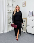 Midi dress with a slit made from polyester and viscose, model with elegant design, shown in the image.