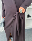 Stylish midi dress with a slit made from polyester, viscose and lycra, shown on a model, suitable for elegant appearance.
