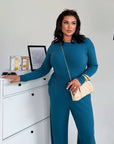 Two-piece set made from polyester and elastane, image of elegant model with modern garment.