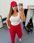 Knit joggers with New Year print, material 60% cotton, 35% polyester, 5% elastane, for comfort and style.
