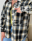 Oversized checked shirt made from cotton and polyester, image of shirt with large square patterns and loose fit.