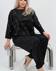 Velvet dress with pearls, with viscose, cotton and elastane, stylish design, shown in the image.