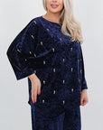 Velvet dress with pearls, with viscose, cotton and elastane, elegant and stylish, shown in a photo.