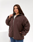 Lightweight hooded jacket made from polyester, black and fluffy, suitable for winter and autumn days, model from the brand.