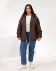 Lightweight hooded jacket made from polyester, image of jacket with visible texture and hood, suitable for everyday use.