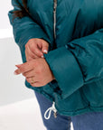 Lightweight hooded jacket made from polyester, suitable for winter conditions, with soft and comfortable design, in a light colour.