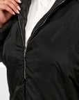 Lightweight hooded jacket made from polyester, suitable for spring and autumn, in a light colour, shown in the image.