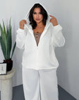 Hooded knit set, containing 60% cotton, 35% polyester and 5% elastane, in neutral colours.