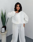 Hooded knit set, contains 60% cotton, 35% polyester and 5% elastane, in the image.