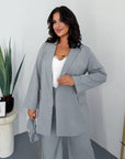 Striped business-style set with polyester, viscose and spandex, shown in the image.